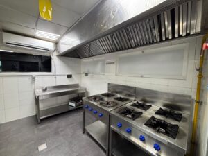 Gas cooking range and extraction hood in a Kitchen Works hot kitchen in Al Quoz 4