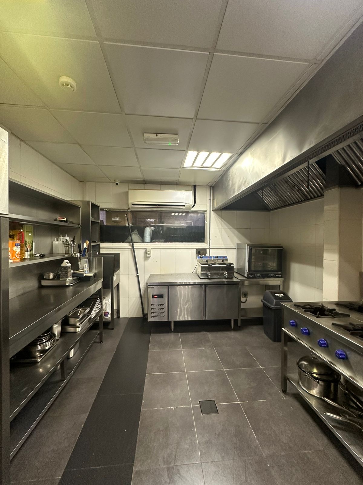 Stainless work surfaces and cooking equipment inside a Kitchen Works unit